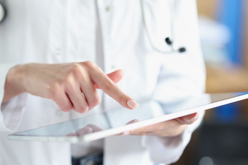 Medical officer doctor points his finger at tablet