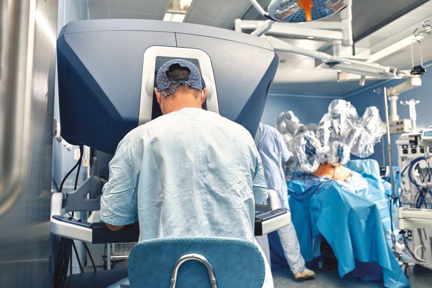 Carrying out an operation using a robot, a robot surgeon with manipulators, a modern operating room, surgeons people perform an operation using a surgeon2700s robot through the control panel2e00
