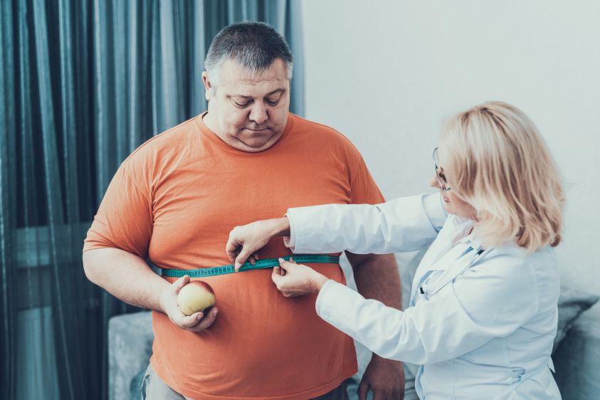 Fat Man with Doctor in White Coat in Gray Room2e00